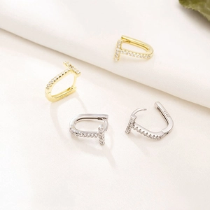 Macro view of S925 silver T-shaped hoop earrings with sparkling pavé cubic zirconia