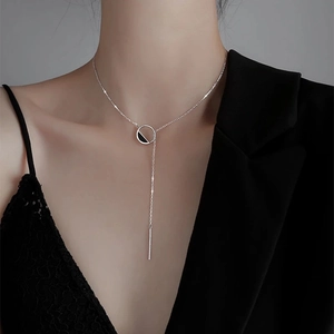 Detail of S925 silver Y-shaped necklace with black enamel ring and vertical bar on model