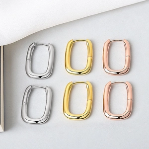 Three pairs of U-shaped geometric hoop earrings in gold, silver, and rose gold finishes