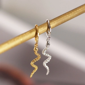 Elegant gold and silver S-shaped snake hoop earrings with detailed metallic scale texture