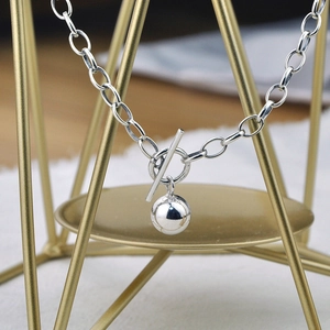 Modern 925 silver beaded pendant necklace with OT toggle clasp on a minimalist display