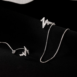 Close-up of S925 silver wave lightning earrings with zircon pavé and box chain detail