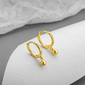 Detailed close-up of S925 sterling silver ball drop earrings with gold plating finish