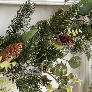 Christmas garland with pine needles eucalyptus leaves pine cones and faux snow flocking