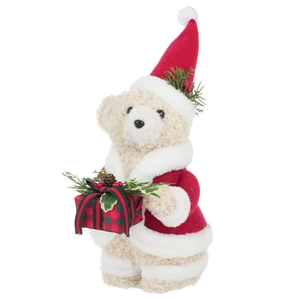 Christmas teddy bear in red santa outfit holding a plaid gift box with pine cones