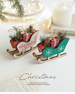 Detail of wooden Christmas sleigh ornaments with pine needles and red berries