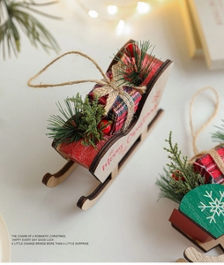 Detail of wooden Christmas sleigh ornament with Merry Christmas text and red berries