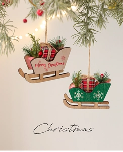 Close-up of wooden Christmas sled ornaments with pine branches and plaid gift boxes