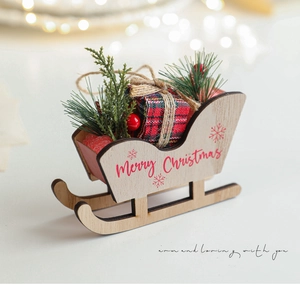Detail of wooden Christmas sleigh with pine needles, red berries and plaid gift box