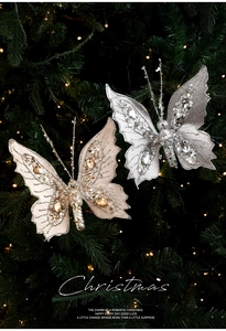 Sparkling silver and gold butterfly clips with sequins and rhinestones on a Christmas tree