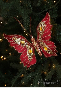 Detail of red velvet butterfly ornament with gold sequins and gems on Christmas tree