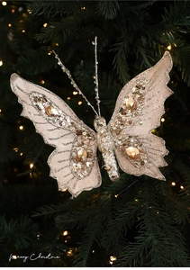 Close-up of champagne gold butterfly ornament with sequins and pearls on Christmas tree