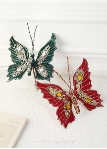 Macro detail of glittery butterfly clips with sequins and gems on white plush background