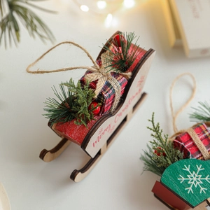 Wooden Christmas sleigh ornament with Merry Christmas text and festive pine needle decor
