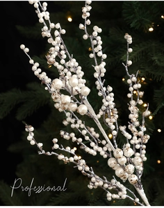 Close-up of white decorative Christmas branches with pearls and golden glitter accents