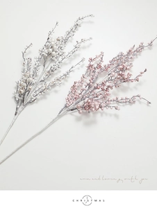 Macro detail of pearlescent pink and white artificial berry stems for Christmas decor