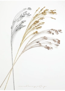 Close-up of glitter wheat sprigs in gold, silver, and rose gold for Christmas decor