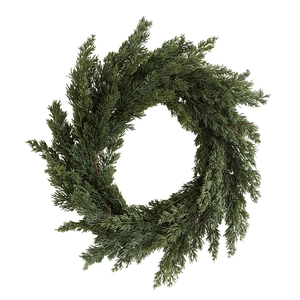 Lush artificial cedar Christmas wreath with dense green needles on a white background