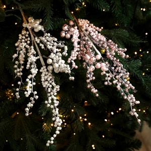 Christmas glitter berry stems with white and pink pearls on festive tree branches