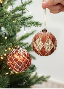 Nahaufnahme von braunen 8cm Weihnachtskugeln mit Goldglitzer am Weihnachtsbaum