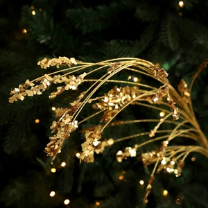 Sparkling gold wheat sprig with sequins for Christmas tree decoration and festive floral arrangements