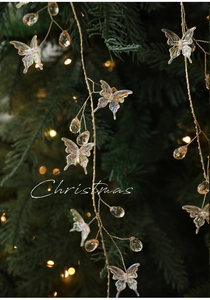 Close-up of sparkling crystal butterfly ornaments with beads for Christmas tree decoration