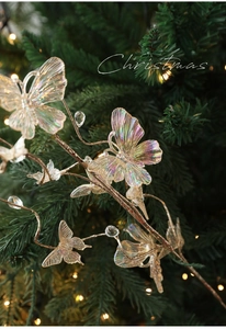Close-up of iridescent butterfly ornaments with pearl beads on a festive Christmas tree branch