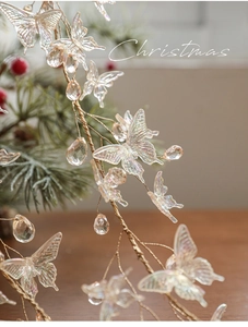 Detail of iridescent butterfly garland with acrylic beads for Christmas tree decoration