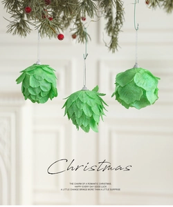 Close-up of green leaf-shaped Christmas ball ornaments with glitter and silver strings