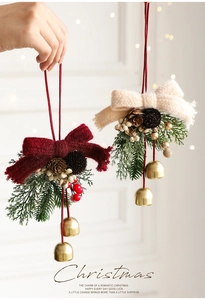 Close-up of knit Christmas bow ornaments with pine cones, red berries and gold bells