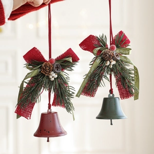 Christmas bell ornaments with red velvet bows, pine cones and berries for festive decor