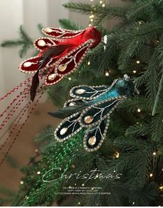 Detail of Christmas bird clip ornaments with velvet, sequins and rhinestones on tree