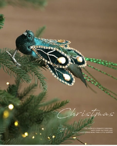 Detail of dark green velvet Christmas bird clip with rhinestones and faux feathers on branch