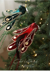 Detailed view of plush velvet Christmas birds with sequins and feathers on a tree