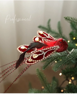 Detail of red flocked Christmas bird ornament with gold rhinestones and feathers