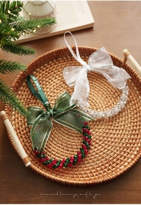 Close-up of beaded Christmas bell ornaments with festive bows and crystal beads