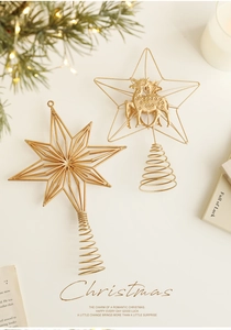 Detailed view of gold metal Christmas tree topper with reindeer and star design