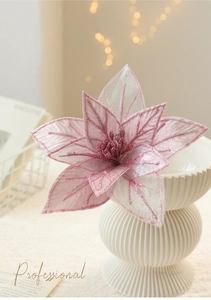 Close-up of pink artificial poinsettia with glitter edges for Christmas tree decoration