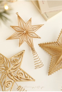 Detailed view of hollow gold Christmas tree star toppers with elegant wire metal textures