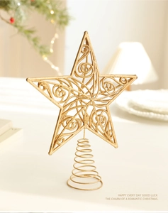 Detail of golden hollow spiral star tree topper with a vintage metal wire design