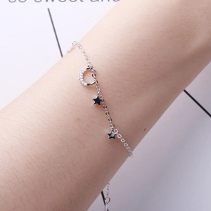 S925 silver star and moon bracelet with zircon pavé worn on a wrist for women