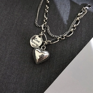 Detail of S925 silver double-layer heart bracelet with Love Forever engraved round tag