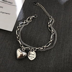 Detail view of double-layer S925 silver bracelet with heart pendant and Love Forever tag