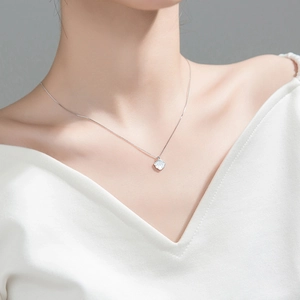 Elegant sterling silver shell necklace with white mother-of-pearl pendant on female model