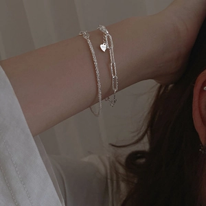Detail of S925 silver double-layer bracelet featuring star chains and heart pendant