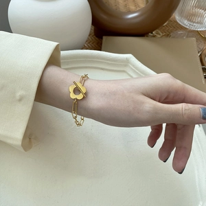 Gold plated paperclip chain bracelet featuring a stylish floral OT toggle clasp design