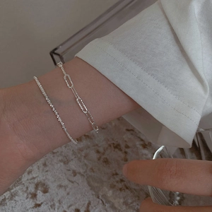 Minimalist double-layer silver bracelet featuring starry chain and paperclip link design
