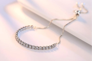 Close-up of adjustable S925 silver bracelet featuring cubic zirconia and bolo slider clasp