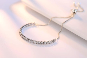 Detailed close-up of adjustable S925 silver tennis bracelet with shimmering cubic zirconia