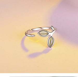 Detailed view of silver open ring with cat eye stone leaf design and adjustable band